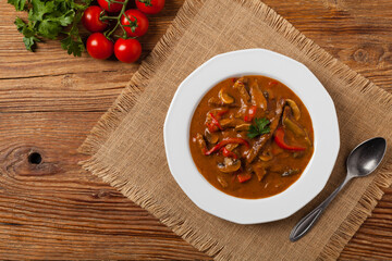 Wall Mural - Boeuf, Stroganow, Strogonow. Classic, Russian beef stew. Served on a white plate. Top view. Natural background.