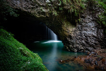 Natural Bridge With Waterfall Into Cave