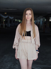 Wall Mural - Young beauty blonde woman with gorgeous long hair enjoying free lazy time in a mall parking