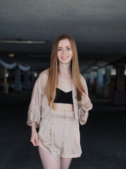 Wall Mural - Young beauty blonde woman with gorgeous long hair enjoying free lazy time in a mall parking