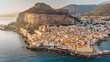 Sunrise over harbor in Cefalu, Sicily, Italy, panoramic aerial view of old town with colorful waterfront houses, sea and La Rocca cliff.Attractive summer cityscape,travel holiday concept background.