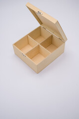 Sticker - Vertical shot of an open wooden box with dividers isolated on light gray background