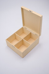 Sticker - Vertical shot of an open wooden box with dividers isolated on light gray background