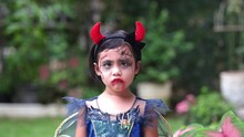 Little Girl In Halloween Costume With Angry Face Expression.