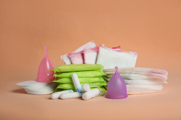 Wall Mural - Menstrual pads and other period products on pale orange background