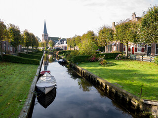 Wall Mural - Houses with waterside gardens on Eegracht canal in IJlst, Friesland, Netherlands