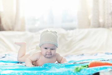 Wall Mural - A newborn baby is lying on a soft bed.