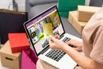 Woman shopping online using her laptop at home