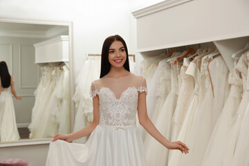 Canvas Print - Woman trying on beautiful wedding dress in boutique