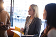 © Wavebreak Media - Diverse group of business colleagues holding documents and having meeting