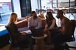 © Wavebreak Media - Diverse group of business colleagues wearing face masks and having meeting