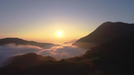 Wall Mural - Sunrise and fog above mountain peaks and hills, forest, Slovenia, aerial view