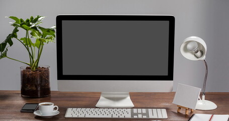 Digital composition of binary coding data processing on computer screen on wooden table