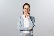 Hmm Very Interesting. Portrait Of Intrigued Cute Asian Woman Making Choice, Deciding Between Variants, Look Camera Satisfied And Smile, Made-up Plan, Listening To Curious Suggestion, Grey Background