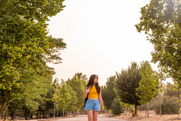 Young caucasian girl walking in the park.