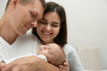 Sticker - Happy family with their cute sleeping baby on grey background