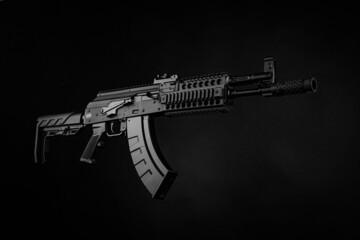 Canvas Print - A pneumatic copy of a Russian machine gun. Modern airsoft weapons. Dark background with red illumination.