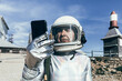© ADDICTIVE STOCK - Senior cosmonaut using mobile phone