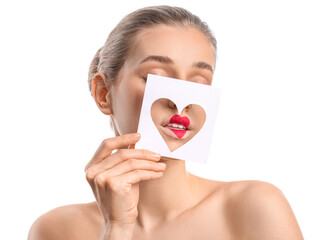 Wall Mural - Beautiful young woman holding paper with cutout heart against white background