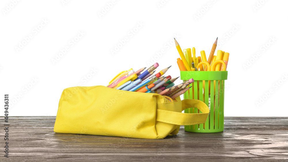 Holder and case with stationery on wooden table against white background
