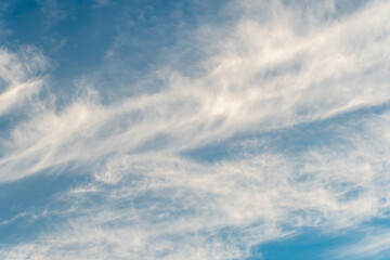 fluffy gentle clouds slowly and hopelessly float across the endless sea of blue sky. Clear blue sky after the raging elements and storms.