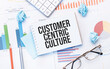 Notepad with text Customer centric culture on the business charts and pen,business