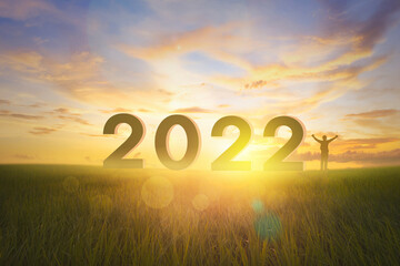 Wall Mural - silhouette year 2022 and man at empty grassland and sunrise