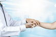 © Muhammadsainudin - Doctor patient care holding hand for advice and encourage.