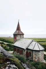 Grense Jakobselv. Cloudy morning in small village in Finnmark county on the shore of the Barents Sea on a foggy day. Arctic Northern Norway landscapes. King Oscar II Chapel. Norwegian stone church