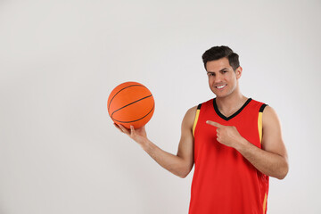 Canvas Print - Basketball player with ball on grey background. Space for text