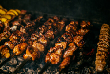 potatoes and shish kebab are fried on the grill