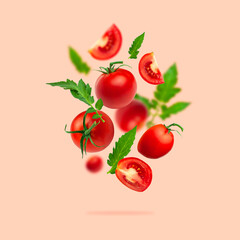 Wall Mural - Creative food concept. Tomatoes pattern. Flying red ripe juicy tomatoes and green leaves on pink background. Healthy vegan organic food, vegetable, cherry tomatoes, summer, harvesting