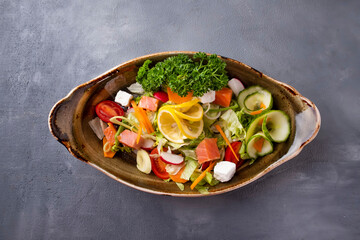 Wall Mural - Tasty salad with salmon and fresh vegetables. Top view