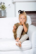 © iordani - little cute blond girl at home interior happy smiling close up, lifestyle people concept