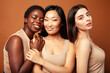 © iordani - young pretty asian, caucasian, afro woman posing cheerful together on brown background, lifestyle diverse nationality people concept
