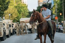Man On Horse Near National Guard