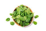 Fototapeta Kuchnia - Fresh spinach leaves on wooden plate. Healthy vegan food. Top view. isolated on white background.