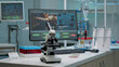 © DC Studio - Microscope on laboratory desk with medical research equipment at hospital clinic. Modern technology used for scientific experiment with vacutainers, pipette and scientific computer