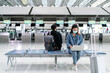 © Yingyaipumi - New normal,bubble travel and social distancing concept.Traveler man and woman wearing face mask and waiting to board at terminal airport for protection coronavirus(covid-19) during virus pandemic