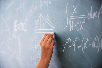 Wall Mural - Teacher or student writing on blackboard during math lesson in school classroom