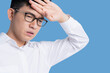 © whyframeshot - sick asian glasses male adult Headaches & Migraines hand touch head with stressful and tension white background health ideas concept