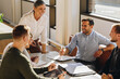 © Jacob Lund - Smiling female executive talking in meeting