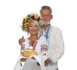 Poster - Happy mature couple in national clothes with bread and salt on white background. Ukrainian welcoming tradition