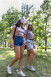 © hannamartysheva - Mom and teenage daughter take a walk in the summer park. Using a smartphone