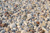 Fototapeta Desenie - Sea stones background. Flat lay of sea stones texture background. Abstract shape pattern from nature.