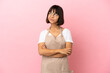 © luismolinero - Restaurant waiter over isolated pink background looking up while smiling