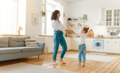 Wall Mural - Mom and her daughter are dancing.