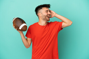 Wall Mural - Young Caucasian man playing rugby isolated on blue background smiling a lot