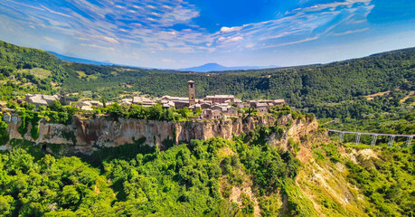 Panoramic aerial view of Civita di Bagnoregio from a flying drone around the medieval city, Italy.