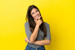 © luismolinero - Young Brazilian woman isolated on yellow background happy and smiling
